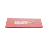 A flat, rectangular cutting mat with a red cover lies on a white background. A label with text and images is visible through the clear plastic wrapping, suggesting it's new, unopened, and features a flexible design.