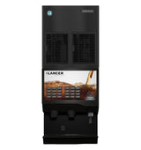A black commercial soda fountain machine with multiple drink selection buttons, a digital display showing a fizzy cola pouring over ice, and a dispensing area below. The Lancer brand name is visible above the screen, paired with an air-cooled cubelet ice maker.