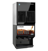 A commercial beverage dispenser, predominantly black and silver, features a Hoshizaki air-cooled cubelet ice maker. The front panel shows cola poured over ice, with push buttons for each drink flavor above spill trays and dispensing nozzles.