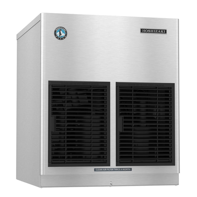 A stainless steel Hoshizaki ice maker with two large black vents on the front, a round certification sticker on the upper left, and a small rectangular label on the upper right. A white label below the vents reads “CLEAN AIR FILTER TWICE A MONTH.”.