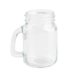 A clear, empty glass mason jar with a handle on the left side is shown against a plain white background. The wide mouth and smooth surface make it easy to use and clean, and this mason jar is also dishwasher safe for added convenience.