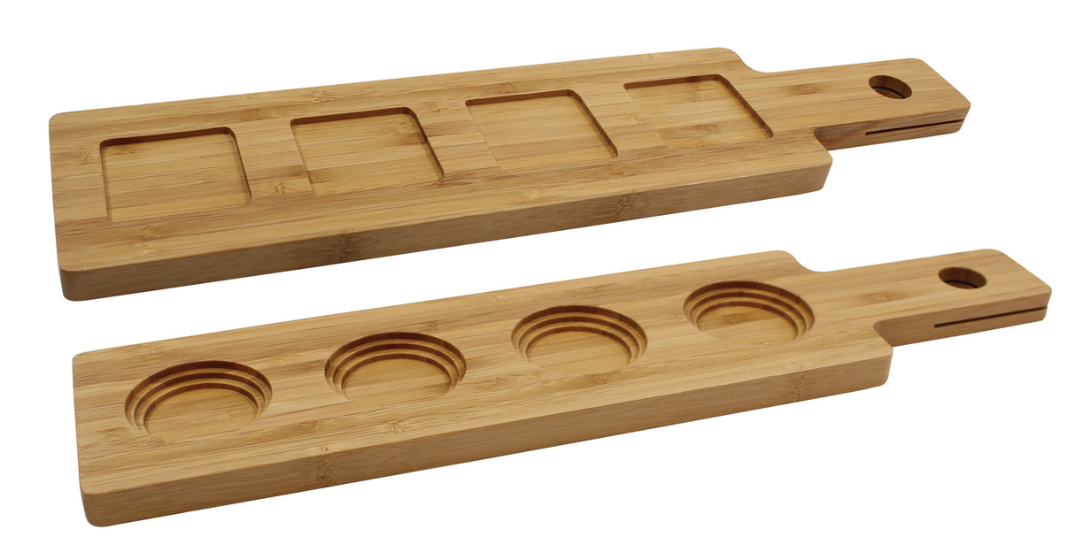 Two rectangular TableCraft FLIGHT1 bamboo flight boards with handles and end holes. One board has four square indentations, the other four circular, perfect as a wood paddle flight for serving cups, bowls, or snacks. Smooth with visible bamboo grain.