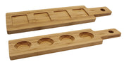 Two rectangular TableCraft FLIGHT1 bamboo flight boards with handles and end holes. One board has four square indentations, the other four circular, perfect as a wood paddle flight for serving cups, bowls, or snacks. Smooth with visible bamboo grain.
