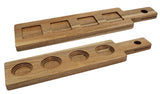 Two rectangular acacia wood paddle flight boards with handles and holes for hanging. The top has four square depressions, the bottom four round, perfect for holding glasses or cups. Smooth finish—ideal for cash & carry.