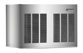 A large, rectangular, silver standalone metal unit with multiple black ventilation grilles on the front and side. Labeled “Goodman” in the upper right corner, it resembles a high capacity ice machine or HVAC system against a plain white background.