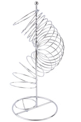 A shiny, chrome plated metal spiral shaped into a ramp curves around a central vertical rod, mounted on a circular base. The spiral design hints at a decorative TableCraft fruit basket or dispenser, possibly for spheres or balls.