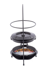A black metal two-tiered Fajita Tower Kit holds two round cast iron fajita platters, one above the other. The lower pan displays a printed food image, while the upper pan is topped with a matching black lid on a white background.