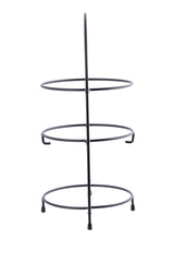 A vertical, black powder coated metal stand features a 3-tier design with three circular rings stacked and four short legs at the base—minimal and open, it's ideal as a Fajita Rack or for holding plates and pot lids.