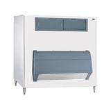 A large, industrial ice bin with a rectangular white body and 1000 lbs storage capacity stands on four metal legs. It features a dark gray front panel and a slanted access door beneath. The clean, utilitarian design suits any commercial setting.