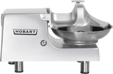 A silver Hobart Food Cutter with a large stainless steel bowl, flat-topped control knob, and sturdy four-legged base. The Hobart logo stands out on the machine’s side, emphasizing its commercial quality and reliability.