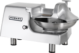 A silver Hobart Food Cutter with a large stainless steel bowl, sturdy base, and branded logo on the side. The machine boasts a sleek, industrial design with four short metal legs, set against a plain white background.