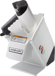 A commercial stainless steel Food Processor with a silver body, labeled HOBART on the front. It features a cylindrical feed chute for continuous feed, a black pusher handle, warning label, and green and red power buttons on the sturdy base.