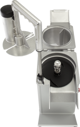 A commercial Food Processor with a metal base and open lid reveals stainless steel cutting surfaces inside. Next to it, a cylindrical plunger and chute allow for continuous feed, making slicing or grating ingredients efficient and effortless.