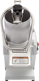 A silver industrial food processor with a large stainless steel bowl, safety handle, and a warning label on the front. The machine has a Hobart logo, control buttons on the side, and a closed bowl lid for continuous feed in commercial kitchens.