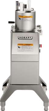 A stainless steel Hobart FP300I continuous-feed food processor stands on four sturdy legs. The machine has a cylindrical top with two white pushers, a control handle, warning labels, and the Hobart logo on the front of the rectangular body.