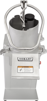A stainless steel Hobart commercial food processor featuring a vertical cylindrical hopper, curved handle, control buttons, and “HOBART” logo above a yellow warning label. Designed for continuous feed, its photographed from above on a white background.