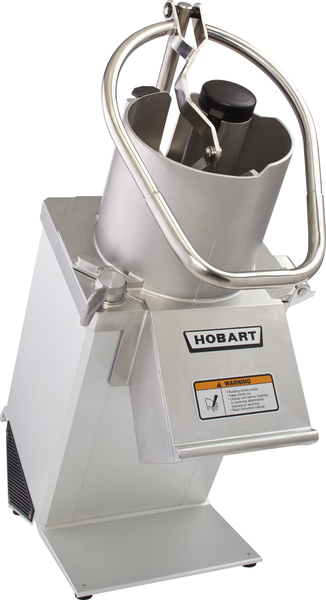 A commercial food processor with a stainless steel body, labeled “Hobart.” It features a large cylindrical feed tube for continuous feed, a pusher handle, and a safety warning label. The device is angled, highlighting its sturdy, industrial design.