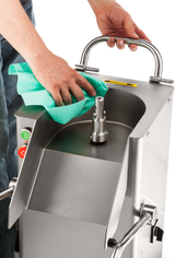 A person cleans a Hobart FP400I Continuous-Feed Food Processor with a green cloth, focusing on the central metal spindle. The machine features start and stop buttons, a top handle, and can handle 132 lb/minute production. The background is plain white.