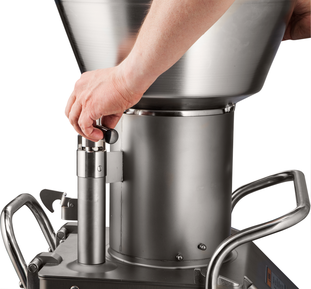 A person’s hand adjusts a black knob on a Hobart FP400I Continuous-Feed Food Processor, a large stainless steel machine with a funnel-shaped top and sturdy handles, capable of processing up to 132 lb/minute with its robust, industrial design.