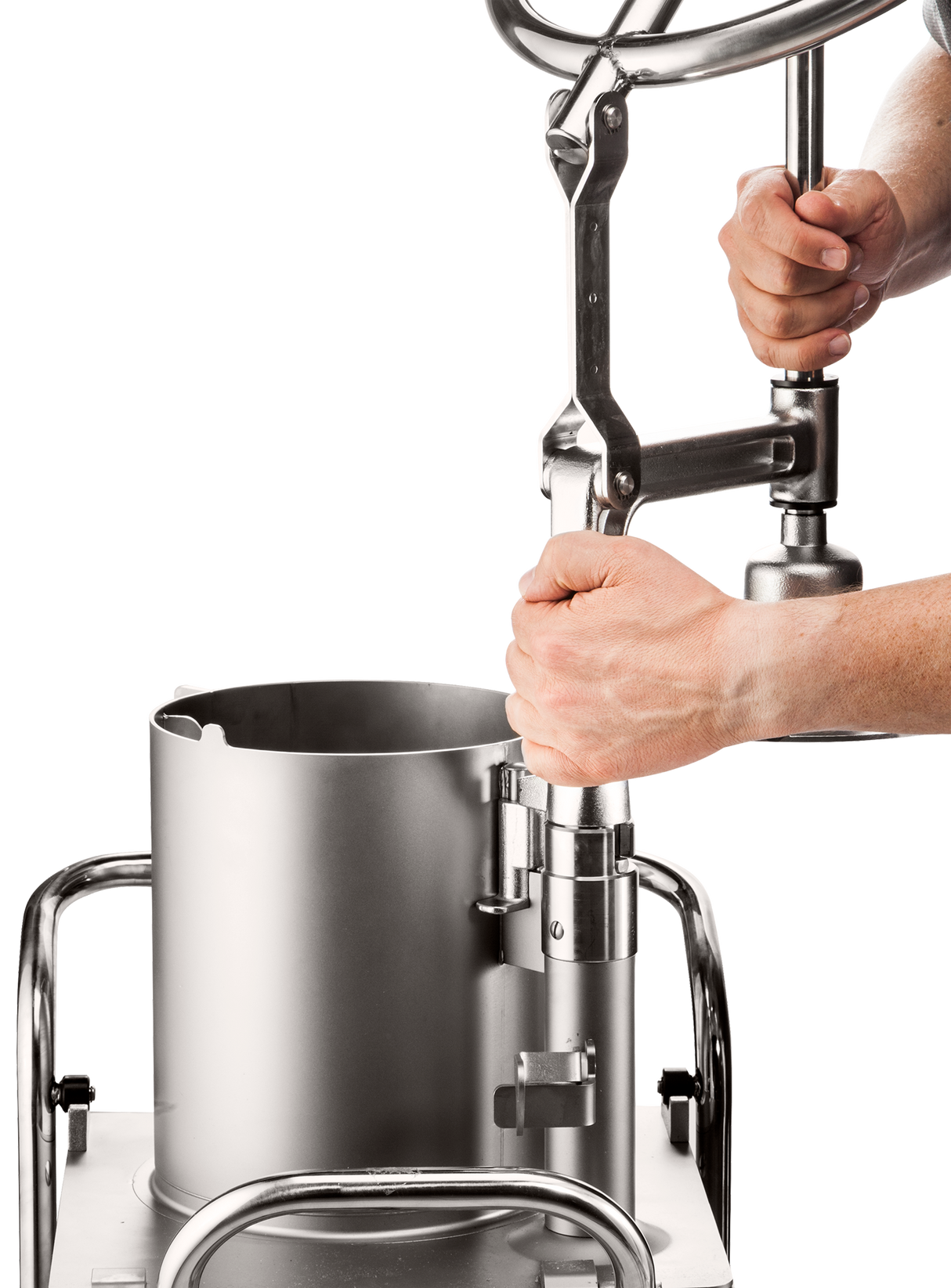 A person’s hands operate a large, stainless steel sausage stuffer, turning a crank handle above a cylindrical container. Similar to the efficiency of the Hobart FP400I Continuous-Feed Food Processor, this machine is set on white with shiny metal rails.