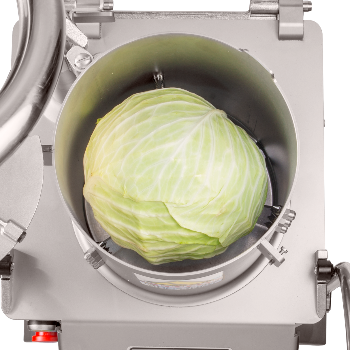 A whole green cabbage sits inside a Hobart FP400I Continuous-Feed Food Processor, viewed from above. The cabbage is centered in the clean, industrial chamber, surrounded by sharp blades ready for 132 lb/minute production.