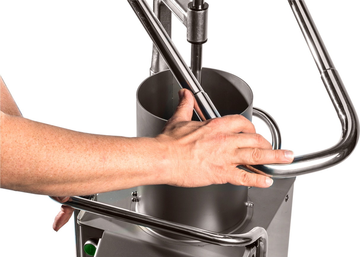A close-up of a persons hand gripping the metal handle of a Hobart FP400I-1 Continuous-Feed Food Processor, made of stainless steel with cylindrical and tubular components, designed for 132 lb/minute production against a plain white background.
