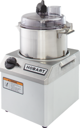 A silver Hobart commercial food processor with a stainless steel 4 qt bowl, clear lid, handle, and control knob on the front. A warning label and the word HOBART are displayed prominently on its sleek metallic body.