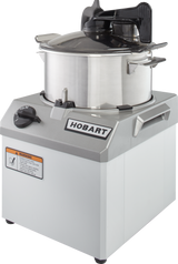A stainless steel Hobart Food Processor with a 6 qt. bowl and COOLCUTTER knives sits on a gray base. The base has a black control knob, “HOBART” logo, warning label, and sturdy handles. The lid features a black handle and safety features.