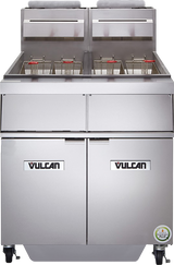 A large commercial stainless steel gas deep fryer with two basket fryers, dual lids, temperature controls, storage compartments below, and a built-in filtration system. The Vulcan brand name is visible on both doors, with an energy efficiency sticker below.