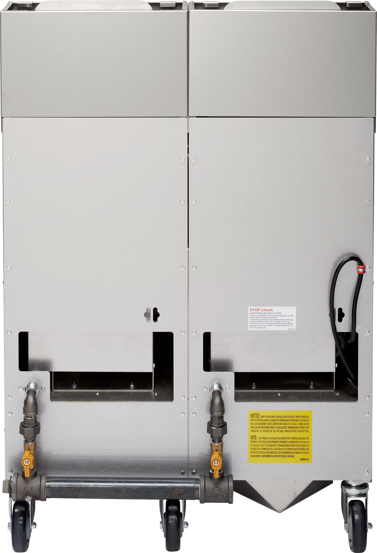 Rear view of a large, industrial high efficiency fryer on four black caster wheels, featuring pipes, shutoff valves, warning labels, and connection points near the bottom; one black cable extends from the right side.
