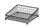 A black powder coated metal, square-shaped wire mesh tray with a grid pattern, raised edges, and four rounded feet. Part of the Grand Master Collection Basket by TableCraft Products, it’s designed for holding items like napkins or papers.