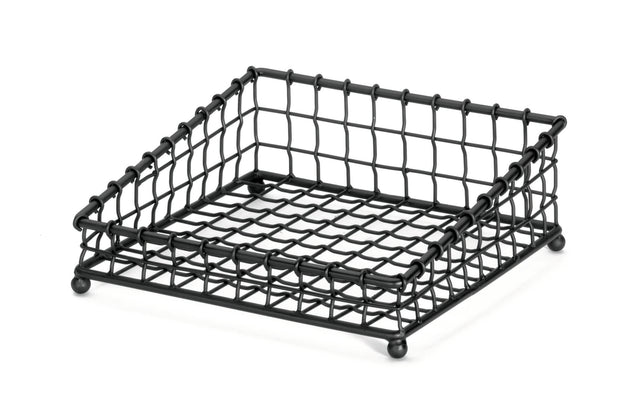 A black powder coated metal, square-shaped wire mesh tray with a grid pattern, raised edges, and four rounded feet. Part of the Grand Master Collection Basket by TableCraft Products, it’s designed for holding items like napkins or papers.