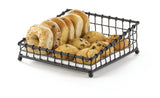 A black powder coated metal TableCraft Products Grand Master Collection Basket holds four bagels and six chocolate chip muffins, arranged neatly in two rows, on a white surface with a simple, clean background.