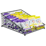 A black powder coated metal Grand Master Collection Basket by TableCraft Products holds several small bags of SkinnyPop popcorn, organized in two rows—white bags with purple accents (Sweet & Salty Kettle) in front and yellow-accented bags in back.