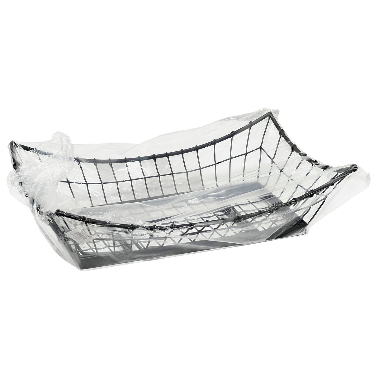A TableCraft GM1608 rectangular black metal basket sits on a white background, partially wrapped in a transparent plastic bag. The bag drapes loosely, leaving the Grand Master Collection basket’s wire structure clearly visible.