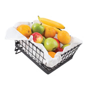 A black powder coated Transformer Basket lined with a white cloth holds assorted fruit—green apples, red apples, oranges, and a banana—against a crisp white background.