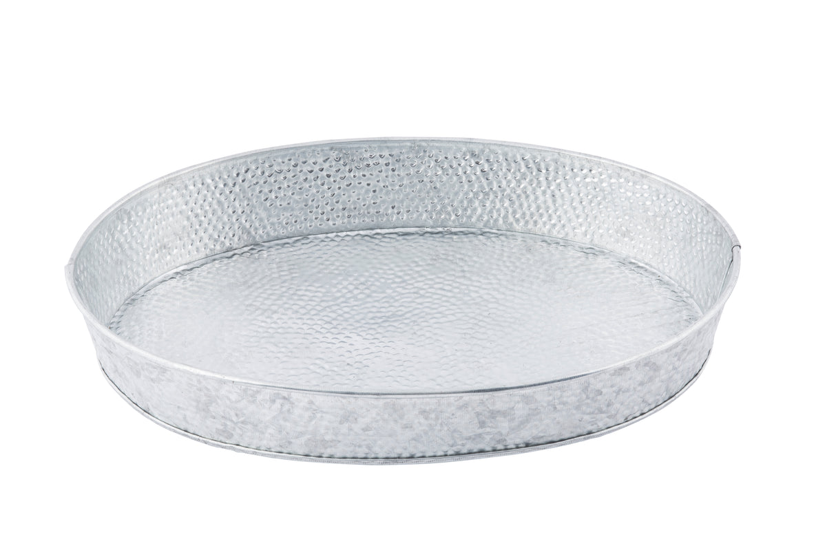 A round, shallow metal tray with a hammered texture and shiny silver finish, similar to the TableCraft GP129. This minimalist oval steel platter features slightly raised sides and is photographed on a white background.