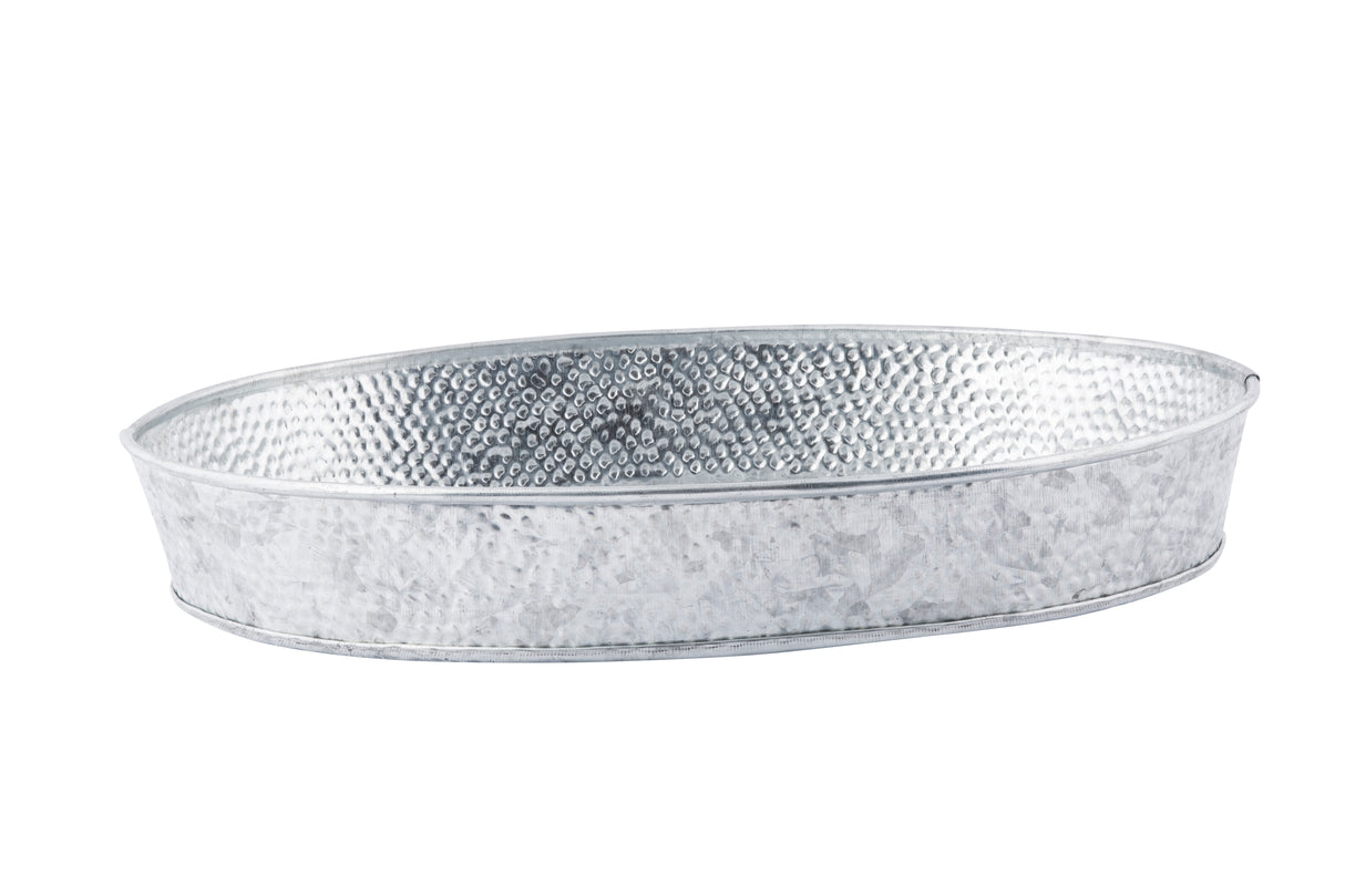 A shallow, oval-shaped metal tray with a hammered texture and silver finish, this galvanized dinner platter features slightly raised edges and a smooth rim for a rustic, industrial look. The background is plain white.