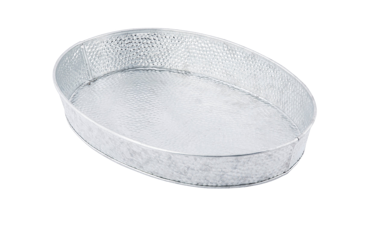 A large, oval-shaped, silver metal tray with a hammered texture, this TableCraft GP129 oval steel platter features slightly raised edges and a shiny, reflective surface. Shown empty against a white background.