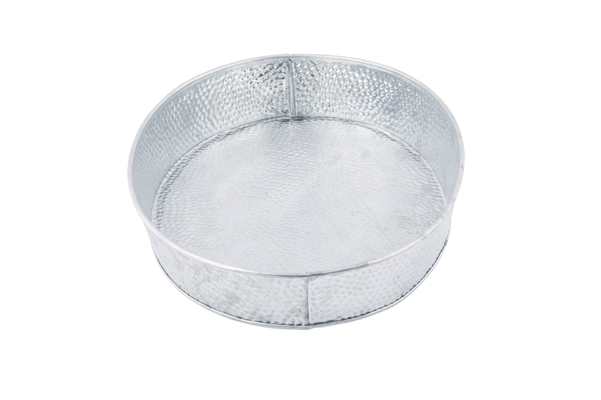 A round, silver-colored metal tray, like the TableCraft GP129 Galvanized dinner platter, features a hammered texture and vertical reinforcement seams around the side. The tray is empty and photographed on a white background.