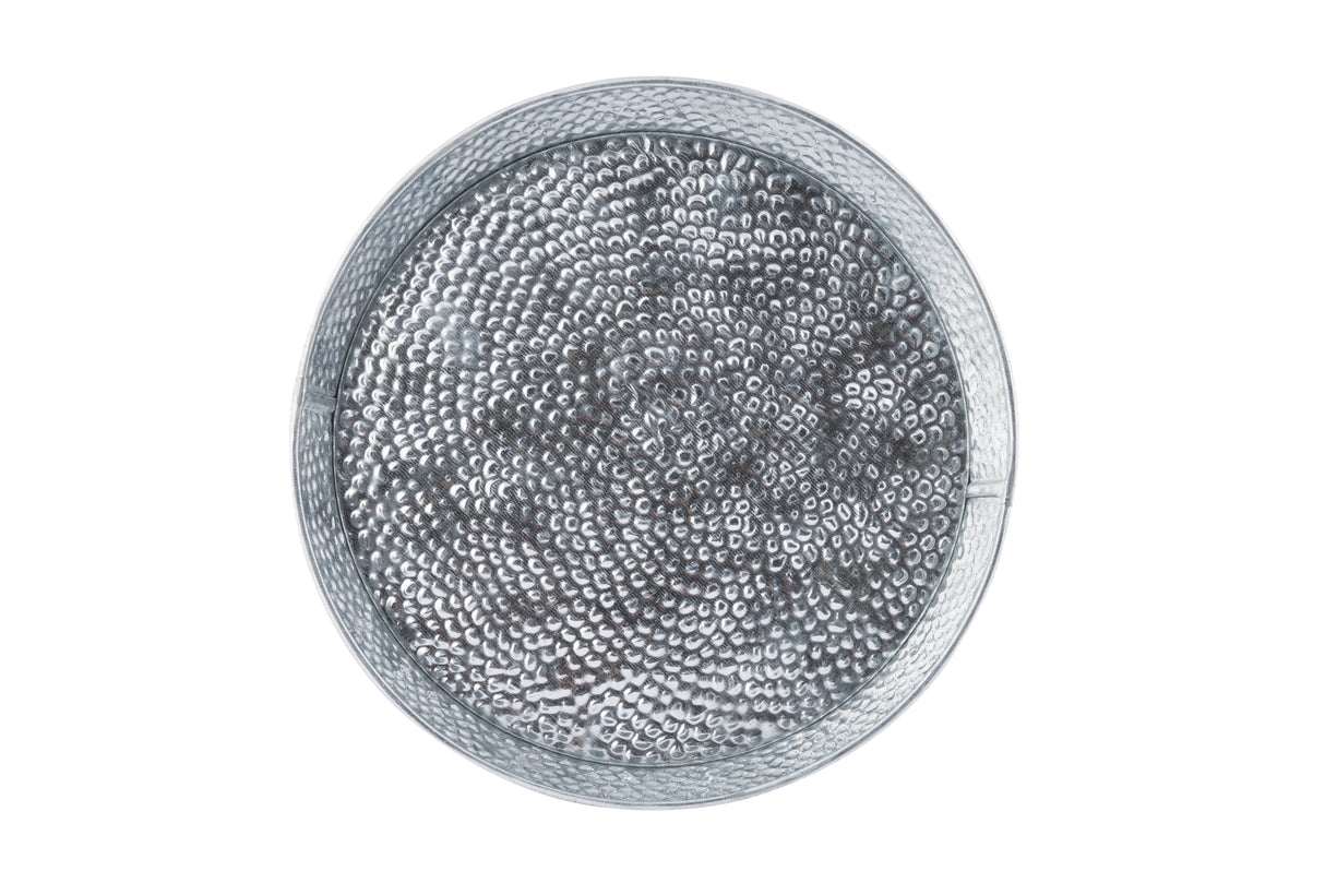 A round, transparent container filled with many small, shiny silver metal pellets resembles a steel dinner platter. The uniform pellets are closely packed and smooth in texture, viewed from above against a white background.