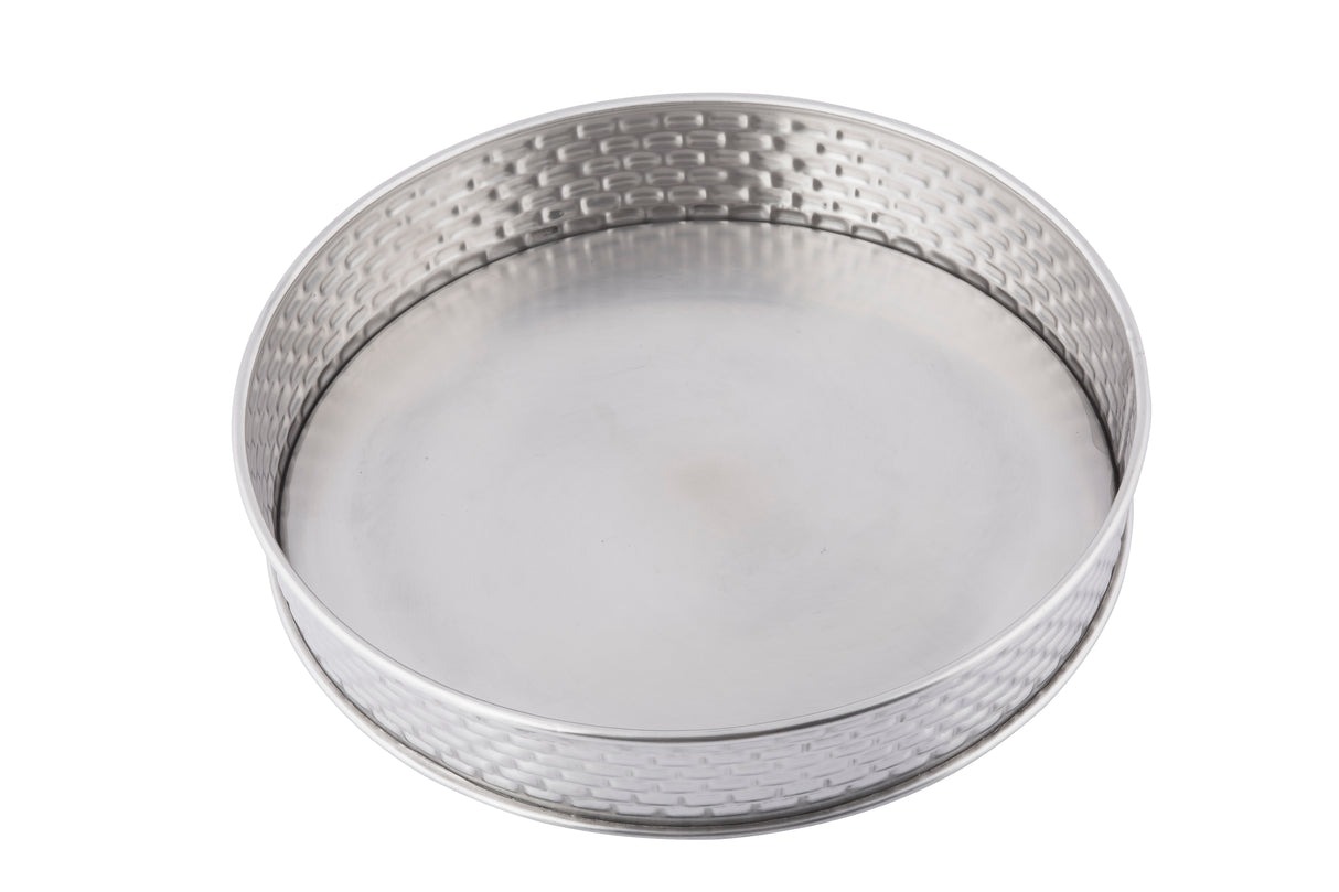 A round, shallow stainless steel serving platter with a smooth flat base and textured, patterned sides. Part of the Brickhouse Collection, the tray is empty and photographed against a white background.