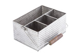 Part of the Brickhouse Collection, this stainless steel flatware caddy features a rectangular, silver basket-weave design with four compartments and a foldable handle with a wooden grip, set against a white background.