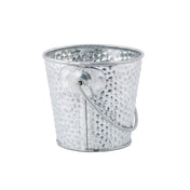 A small, round, silver galvanized pail with a hammered texture and a thin wire handle attached at the sides. The bucket is empty and displayed against a white background.