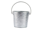 A small, silver galvanized pail with a hammered texture and a thin, curved handle attached on both sides. The steel pail is empty and isolated on a white background, with its handle raised halfway above the rim.