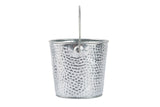 A small, metallic TableCraft Products galvanized pail with a hammered texture and thin metal handle stands upright against a plain white background, its shiny silver surface reflecting light and emphasizing the dimples.