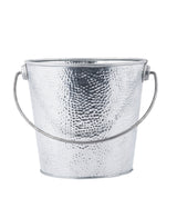 A silver, hammered steel bucket with a rounded base and curved handle attached at the sides. This galvanized pail is empty and shown against a plain white background.