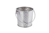 A small, empty stainless steel pail with a brick-patterned texture and a curved handle, shown against a plain white background. The pail is clean, reflective, and dishwasher safe, with the handle attached near the top rim.
