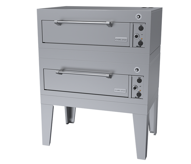 A double-deck commercial bake oven with a stainless steel finish. Each deck has a horizontal handle, rectangular door, and control knobs on the right. The electric deck oven stands on four sturdy legs, with the “Garland” brand visible on both doors.