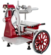 A vintage-style Italian-designed flywheel slicer in red and silver features a large spoked wheel, hand crank, blade guard, adjustable thickness settings, and sturdy legs with suction cups. The word Globe is visible on the side.